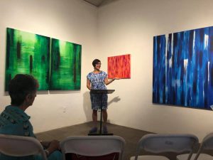 The artist Katyraven Hernandez Dorsey welcomes the audience to the literary art night, "The House of Eternal Belonging," at 5G @ Factory on Fifth.